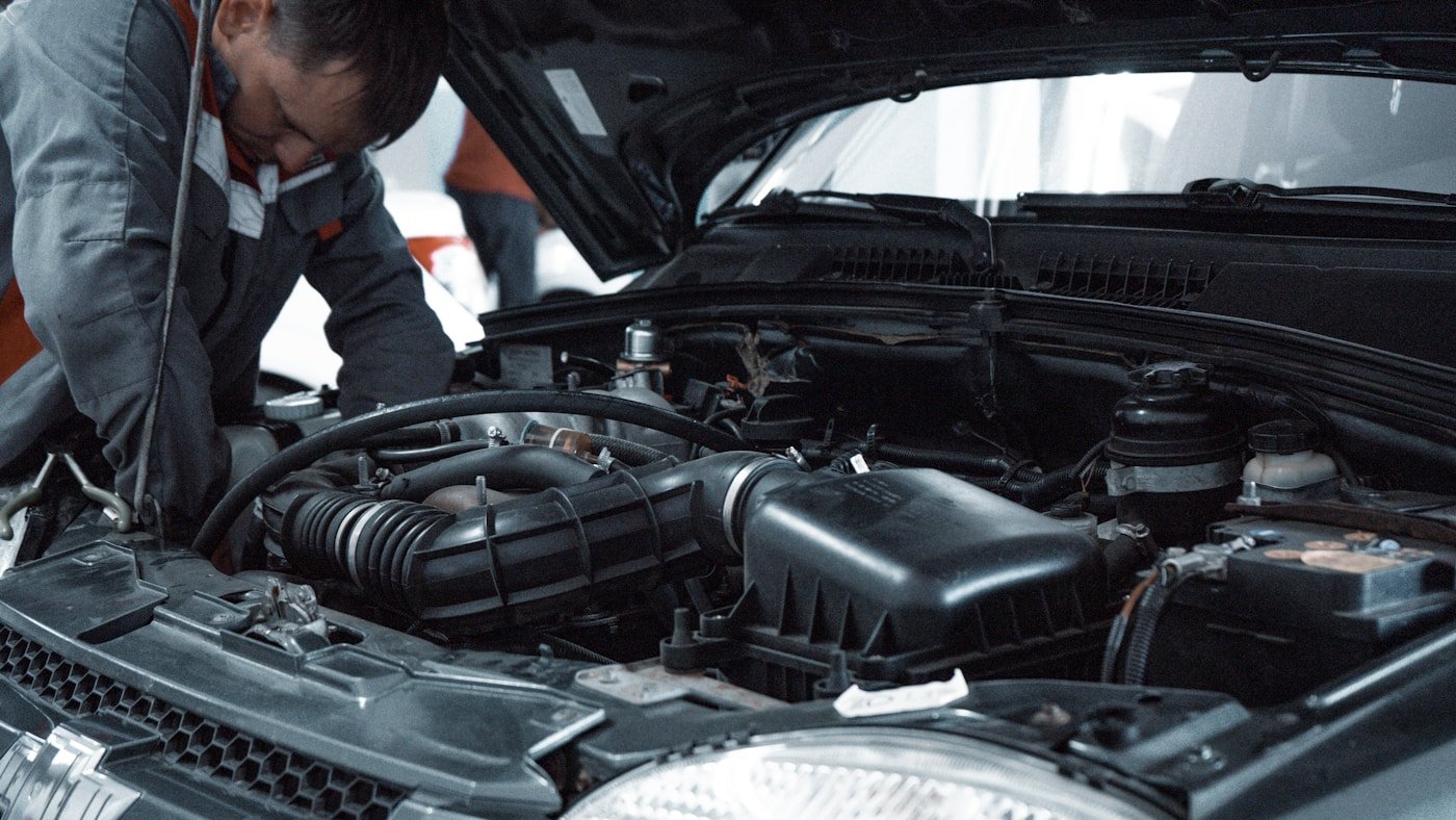 Technician working in a modern vehicle workshop